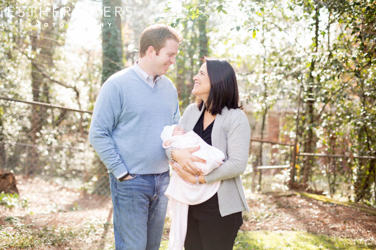 first time parents smiling with newborn baby girl