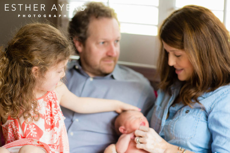 Mom and dad with newborn baby girl and big sister