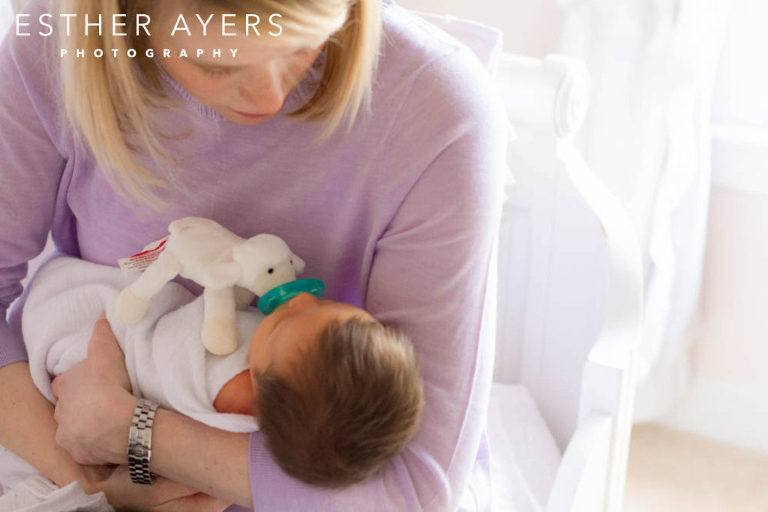 Mom holding Newborn Baby Girl wrapped in blanket