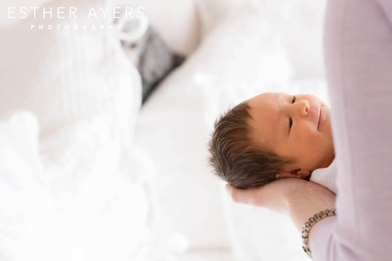 Mom holding Newborn Baby Girl wrapped in blanket