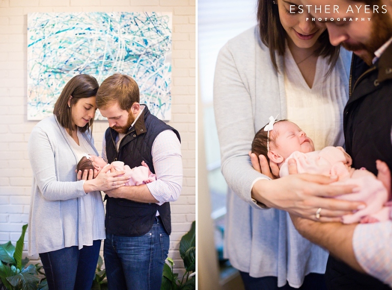 Smiling newborn baby girl with first time parents