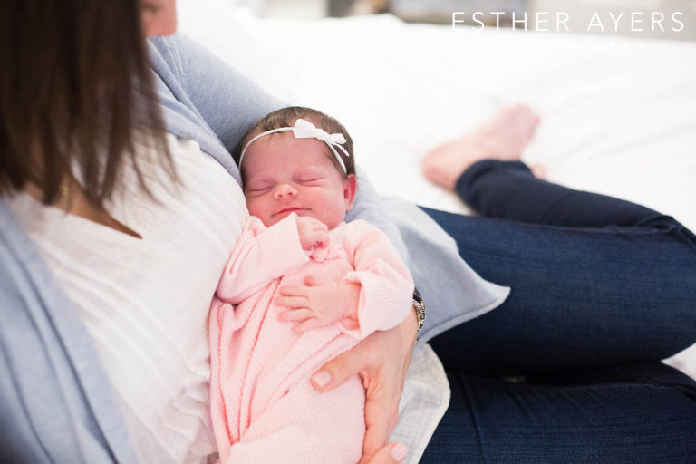 newborn baby girl being held by mom